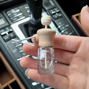 Car air vent perfume diffuser bottle detail view showing wooden cap and glass container.