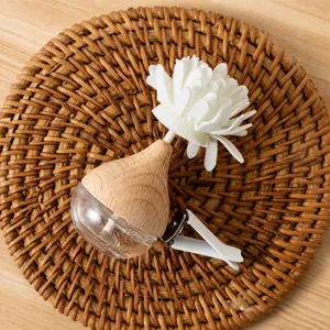 Car air vent perfume diffuser bottle with white flower clip decoration for fresh vehicle aroma.