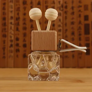 Car vent perfume glass bottle with wooden ball diffuser for automotive aromatherapy fresh air.