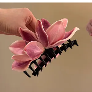 Detailed close-up view of an elegant pink orchid flower hair claw clip for women