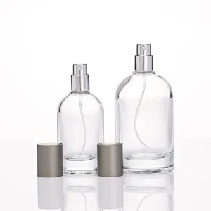 Clear glass perfume atomizers detail view, empty cosmetic spray bottles with silver pump caps.