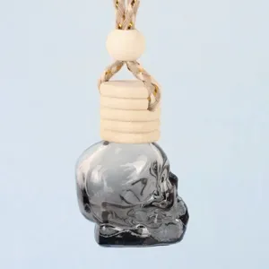 Detailed view of the gradient skull glass car perfume bottle with wooden cap and hanging rope.