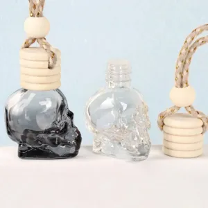 8ml car perfume bottle glass skull diffuser with wooden cap and hanging rope for rearview mirror.