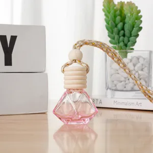 Car hanging perfume glass bottle with wooden cap and pink liquid, stylish rearview mirror pendant.