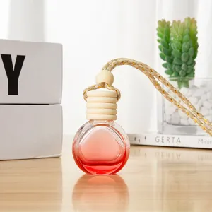Glass car perfume bottle detail view showing wooden cap and red liquid inside clearly.