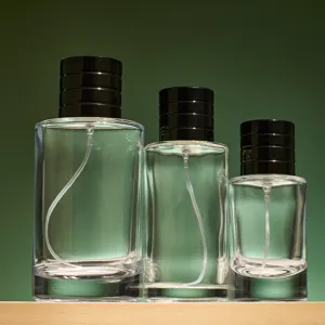 Clear glass perfume spray bottles set, empty refillable cosmetic containers with black caps.
