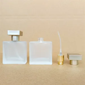 Square frosted glass perfume bottle empty cosmetic spray atomizer with gold cap and pump.