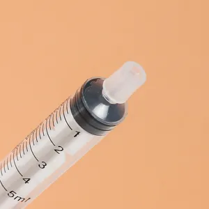 Clear plastic 5ml perfume dispenser syringe tool close-up showing precise volume scale.