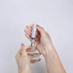 Perfume refilling tool set with precise syringe and glass bottle for easy liquid transfer.