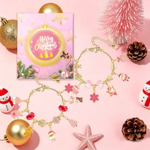 Pink Christmas DIY charm bracelet set featuring gold snake chains and festive charms