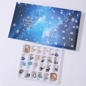 Detailed view of Christmas Advent Calendar DIY jewelry set with 24 charms and blue starry box.