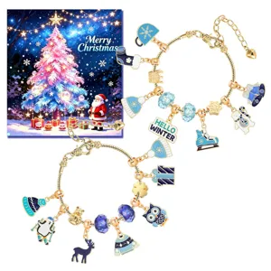 Detail of two gold charm bracelets with blue winter and Christmas themed charms.