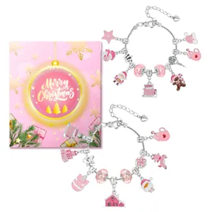 Pink Christmas charm bracelet set with festive charms like Santa and gingerbread man