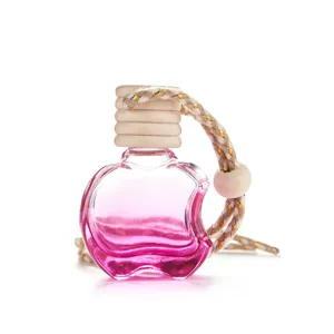 Cute apple shaped car perfume glass bottle with pink essential oil diffuser and braided rope.