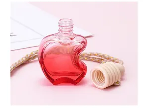 Apple shaped car perfume glass empty bottle detail view with wooden cap and rope.
