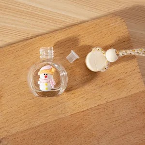 Detailed close-up shot of the clear glass car perfume bottle with cute snowman decor and wooden cap.