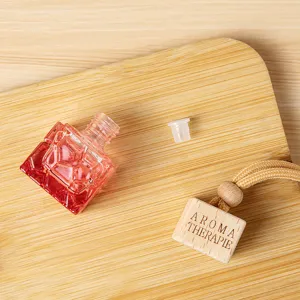 Detailansicht der rosafarbenen facettierten Glas Auto Parfüm Diffusor Flasche mit Holzkappe.