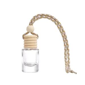 Flacon de parfum vide cylindrique pour voiture avec bouchon en bois et cordelette suspendue.