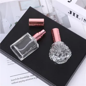Detailed shot of 15ml portable glass perfume spray sub-bottles with rose gold caps and clear body.