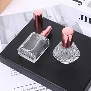 Detail view of 15ml empty glass perfume spray bottles with rose gold caps for travel.