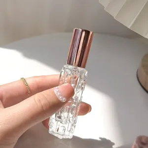 Close-up detail van doorzichtige gestructureerde parfumverstuiver fles met roségouden dop.