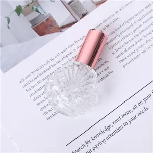 Portable 15ml glass perfume spray bottle with rose gold cap, perfect for travel and cosmetics.