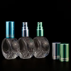 Detailed view of 10ml flat round clear glass perfume spray bottles with metal caps.