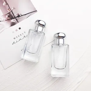 Portable 25ml clear glass perfume atomizers with silver screw caps, ideal travel sub-bottling.