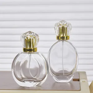 50ml clear glass perfume spray bottle with diamond cap and golden pump for cosmetics.