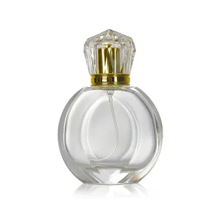 Detail shot of 50ml clear glass perfume bottle with diamond cap and gold spray pump.