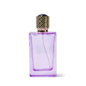 Detailed view of the purple glass perfume bottle with golden ornate cap and spray nozzle.