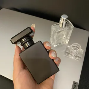 Glass perfume bottle detail shot showing the 30ml black matte container and spray pump.