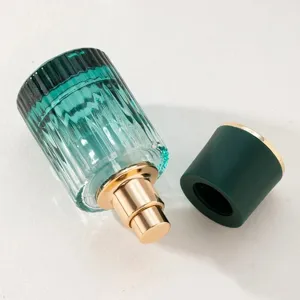 Gradient green glass perfume bottle 30ml empty spray decanter with gold pump and matching cap.