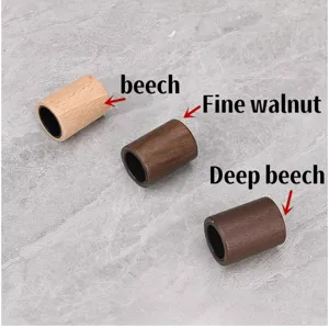 Detailed view of wooden perfume bottle caps in beech and walnut wood finishes, elegant design.