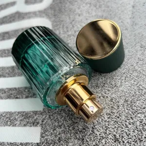 30ml refillable glass perfume bottle with gold spray nozzle and green striped design.