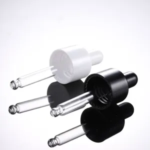 Vue détaillée des bouchons compte-gouttes pour huiles, pipettes en verre noir et blanc.