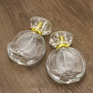 Empty glass perfume bottle detail shot, 50ml refillable cosmetic container with crystal cap.