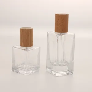 Clear glass perfume bottle with wooden cap, empty spray decant bottle for cosmetics and travel.