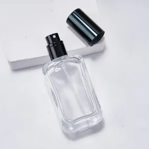 Clear glass perfume bottle detail showing the empty 30ml sample container with black pump.