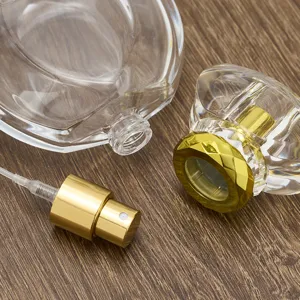 Detailed view of empty 50ml glass perfume bottle with luxury gold pump and diamond cap.