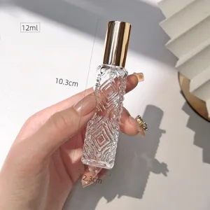 Detailed view of a 12ml diamond patterned glass perfume bottle with gold cap and size marks.