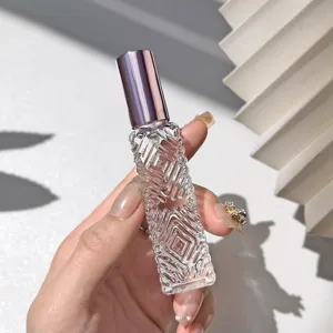 Diamond glass perfume bottle detail view with purple cap and clear textured spray design.