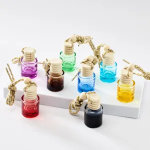 Colorful glass car perfume pendant bottles with wooden caps and hanging ropes for diffuser.