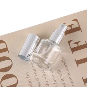 Detailed view of 8ml clear glass perfume spray bottle with silver cap, elegant aesthetic prop.