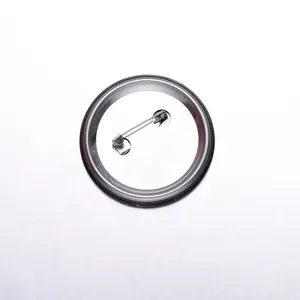 Detailed back view of a round tinplate badge featuring a secure metal safety pin clasp