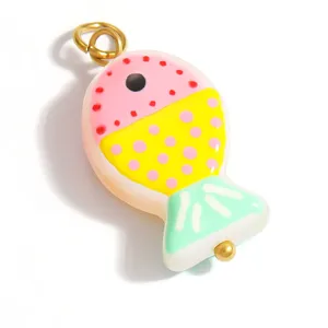 Macro detail of a colorful handmade glass fish charm pendant for DIY jewelry making designs