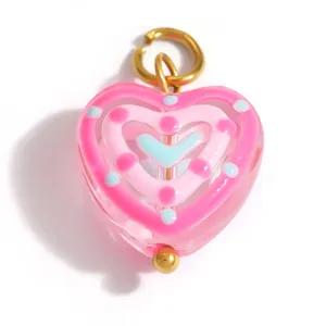 Macro detail of a sweet pink colored glaze heart pendant for DIY jewelry making accessories