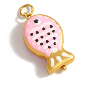 Detailed view of a pink and gold fish pendant with polka dots for DIY jewelry making