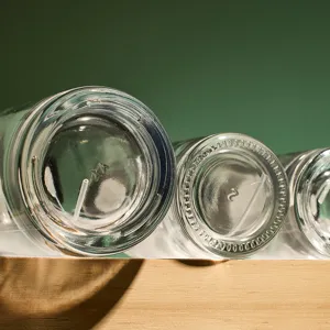 Glass perfume bottle bottom detail, transparent empty refillable cosmetic container closeup.