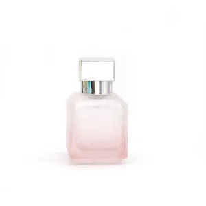 Vue détaillée du flacon de parfum en verre givré rose avec capuchon carré argenté.